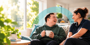 NDIS participant and support worker spending time together in a Supported Independent Living home