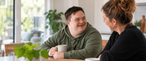 NDIS participant enjoying a conversation at home with a support worker