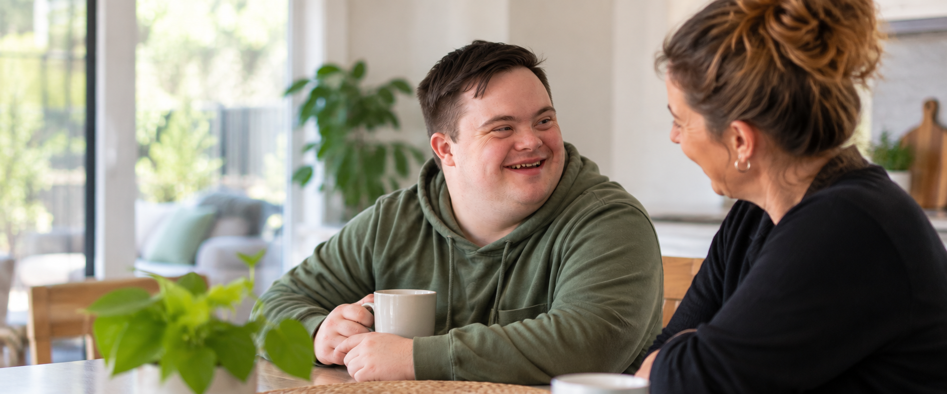 NDIS participant enjoying a conversation at home with a support worker